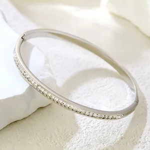 Elegant silver titanium steel bangle with shimmering crystal pavé in a modern design