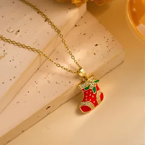 Detail of red enamel Christmas stocking pendant with gold chain and zircon accents