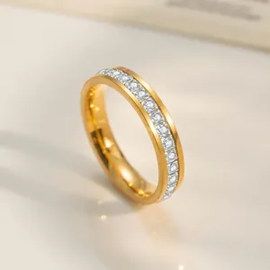 Macro view of gold plated titanium steel ring with channel set row of sparkling zircon stones