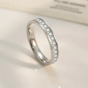 Macro shot of silver titanium steel half eternity ring featuring a row of round-cut crystals