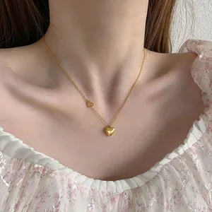 18k gold double heart necklace for women featuring solid and hollow heart pendants