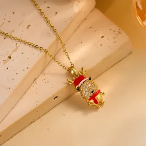Detailed macro view of a gold Christmas reindeer necklace with red hat and crystals