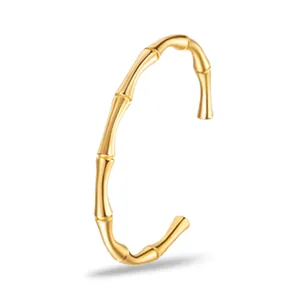 Dettaglio della texture a nodi di bambù lucido e finitura dorata del bracciale aperto