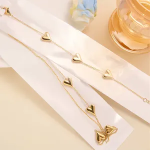 Elegant gold heart charm bracelet with five polished pendants on minimalist thin chain