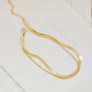 Close-up of golden double-layered snake and box chain anklet with lobster clasp