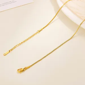 Detail of gold-plated stainless steel box chain necklace with lobster clasp and tag