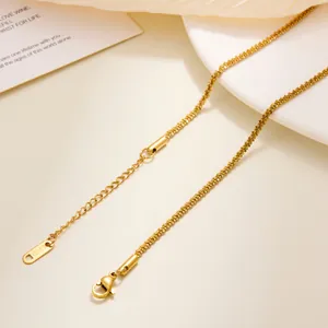 Close-up of gold titanium steel lip chain with lobster clasp and S.STEEL engraved tag