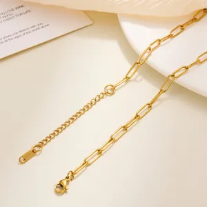 Detail of gold paperclip chain necklace with lobster clasp and S.STEEL engraved tag
