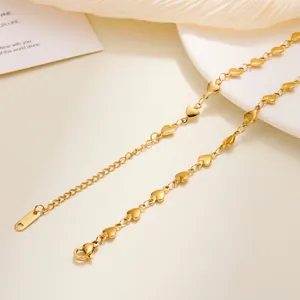 Close-up of gold plated stainless steel heart link chain with S.STEEL engraved tag