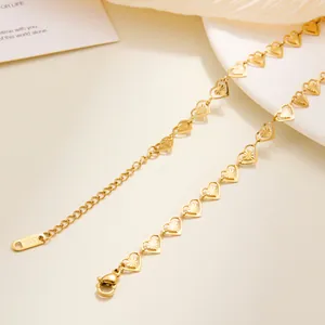 Detailed close-up of gold stainless steel heart chain showing S.STEEL logo tag and clasp