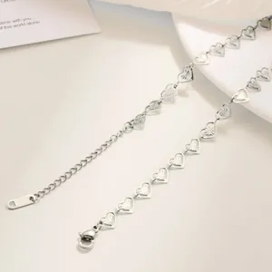 Close-up of stainless steel heart chain with lobster clasp and engraved tail tag