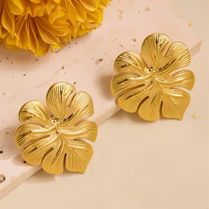 Golden Monstera leaf titanium steel stud earrings with detailed tropical leaf patterns