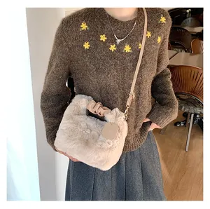 Detailansicht der flauschigen Kunstpelz-Schultertasche mit Lederriemen und Golddekor