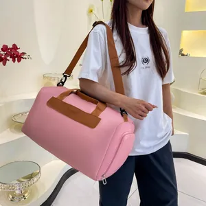 Pink waterproof travel bag shown worn crossbody for yoga or short gym trips