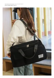 Detailed view of black corduroy travel bag with durable straps and functional pockets
