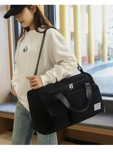 Detail of black large capacity travel bag in corduroy fabric with adjustable strap