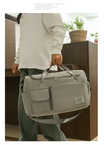 Detail of grey corduroy travel bag with top handles and adjustable shoulder strap