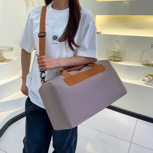 Light purple waterproof fitness bag with brown leather handles worn by a model in style