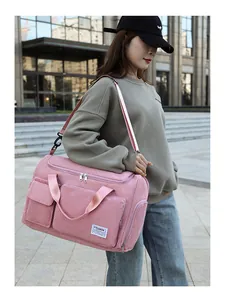 Detailed shot of pink corduroy travel bag showing large capacity and front pockets