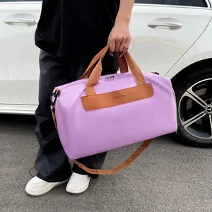 Detail showing high-density purple nylon fabric and fashion leather patch on travel bag