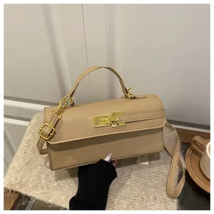 Détail du mini sac beige en cuir à motif litchi avec fermoir métallique doré élégant