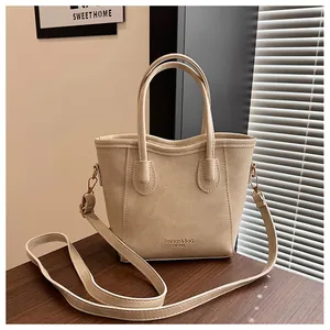 Detail of beige faux leather tote bag with Fashion & BAG text and adjustable strap