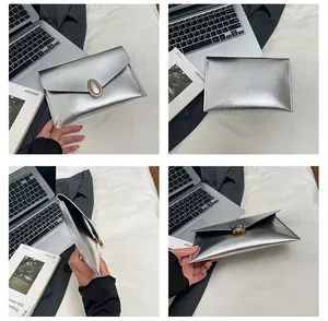 Detailed views of the silver envelope clutch featuring gold buckle and textured leather