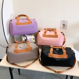 Group shot of colorful travel bags in purple, pink, grey and black with durable handles