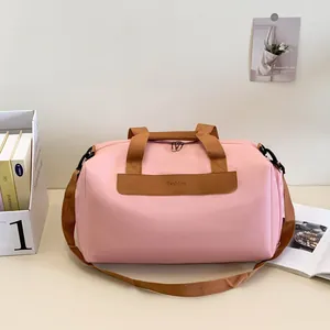 Pink multi-functional travel bag with brown straps and dry-wet separation design