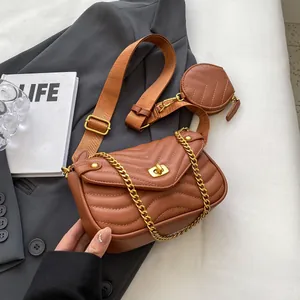 Detailed view of brown quilted crossbody bag with golden chain and mini round pouch