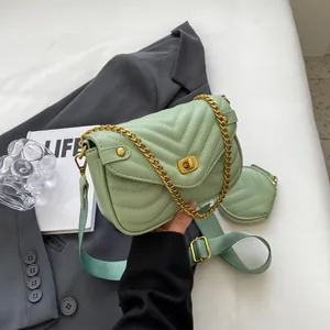 Detailed close-up of mint green quilted crossbody bag with golden chain and round coin purse
