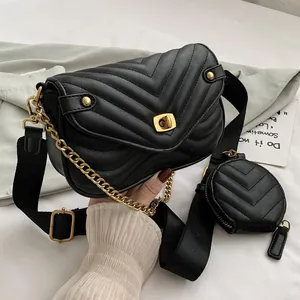 Black quilted crossbody bag with gold lock, wide strap and mini round coin purse