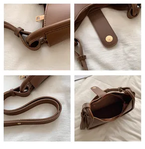 Detailoverzicht van bruine PU-lederen tas met gouden hardware en binnenzak