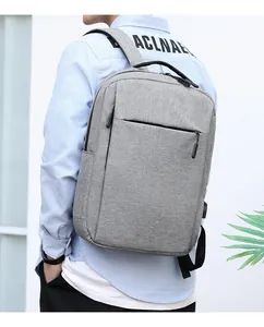 Rear view of model wearing a grey business backpack with ergonomic padded shoulder straps