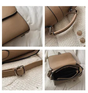 Detailoverzicht van kaki PU-tas met leertextuur, metalen gespen en binnencompartimenten