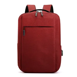 Burgundy business laptop backpack with USB charging port and durable fabric on white background
