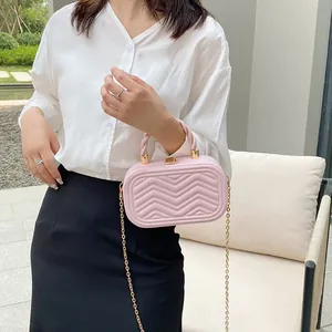 Pink quilted box handbag with gold chain strap and stylish twisted handle for women