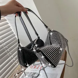 Chic rhinestone-encrusted cylinder handbag set in black and silver with chain straps