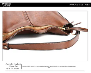 Detailansicht der braunen Leder-Litschi-Textur und des Metallreißverschlusses der Handtasche
