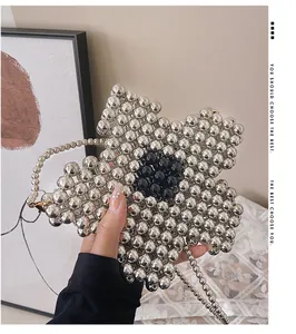 Detail of silver beaded flower bag with black accents and matching beaded shoulder strap