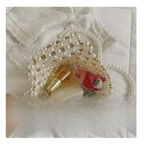 Internal capacity view of handmade pearl beaded shoulder bag showing everyday essentials