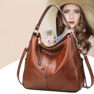 Klassische braune Leder Boston Handtasche mit abnehmbarem Gurt für stilvolle Damen