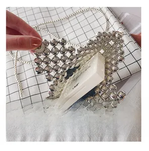 Detail presentation showing silver beaded bag capacity with a compact powder inside
