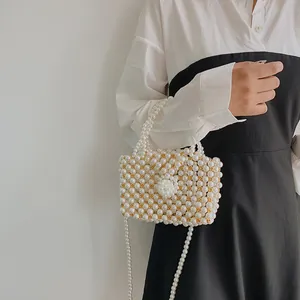 Handmade pearl shoulder bag with gold beads and detachable strap for elegant women