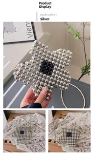 Detail of silver beaded star-shaped handbag featuring intricate hand-woven metallic beads