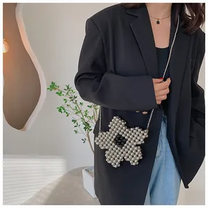 Detail of silver beaded floral crossbody bag with metallic beads and chain strap