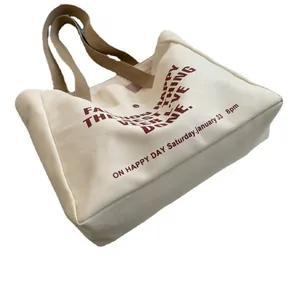 Large capacity canvas tote bag with brown handles and red artistic lettering on white base