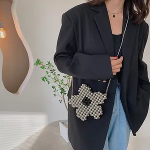 Handcrafted floral beaded crossbody bag with metallic silver petals and black center bead