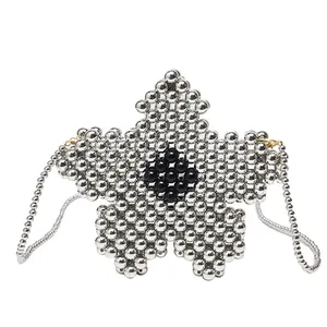 Star-shaped handmade beaded shoulder bag with silver metallic finish and floral pattern