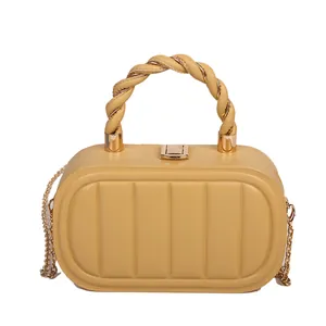 Chic yellow box bag with vertical embossed stripes and woven handle on white background